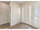 Bright entryway featuring wood-look tile flooring, a white front door, and window sidelights at 4775 E Beacon Ridge Dr, Pahrump, NV 89061