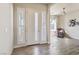 Inviting entryway with wood-look tile flooring, white door with sidelights, and neutral paint at 4775 E Beacon Ridge Dr, Pahrump, NV 89061