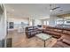 Open-concept living room featuring an adjacent kitchen with stainless steel appliances and a tile backsplash at 4775 E Beacon Ridge Dr, Pahrump, NV 89061