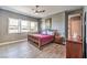 Serene primary bedroom featuring wood-look tile flooring, neutral walls, plantation shutters, and ample natural light at 4775 E Beacon Ridge Dr, Pahrump, NV 89061