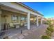 Spacious covered patio with seating area and well-manicured landscaping at 4775 E Beacon Ridge Dr, Pahrump, NV 89061