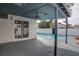 Covered backyard patio with ceiling fan overlooking the sparkling pool at 4775 Monaco Rd, Las Vegas, NV 89121