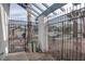 Wrought iron front gate under pergola, revealing a glimpse of the neighborhood beyond at 4775 Monaco Rd, Las Vegas, NV 89121