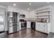 The kitchen features stainless steel appliances, white cabinets, and dark wood flooring at 4775 Monaco Rd, Las Vegas, NV 89121