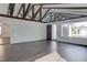 Bright living room features vaulted ceilings with wood beams and an open layout with wood laminate flooring at 4775 Monaco Rd, Las Vegas, NV 89121