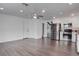 Spacious living room with wood floors adjacent to the kitchen features stainless steel appliances at 4775 Monaco Rd, Las Vegas, NV 89121