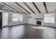 Bright living room features vaulted ceilings with wood beams, fireplace and wood laminate flooring at 4775 Monaco Rd, Las Vegas, NV 89121