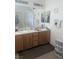 Bathroom featuring a double sink vanity with wood cabinets and large mirror at 4970 Copperlyn St, Las Vegas, NV 89122