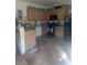 Spacious kitchen with tile flooring, oak cabinets, and black appliances at 4970 Copperlyn St, Las Vegas, NV 89122