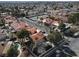 Expansive aerial view of a neighborhood with houses, mature trees, tennis court, and beautiful desert landscape at 5102 Tennis Ct, Las Vegas, NV 89120