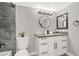 Modern bathroom featuring a gray-toned tiled shower and vanity with black accents at 5102 Tennis Ct, Las Vegas, NV 89120