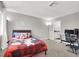 Bright bedroom with carpet, featuring a bed with decorative pillows and a computer desk setup at 5102 Tennis Ct, Las Vegas, NV 89120