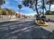 Street view of the gated entrance to the community, featuring lush landscaping and a clear sign at 5102 Tennis Ct, Las Vegas, NV 89120