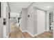 Hallway featuring light wood flooring, doors, and a view of the staircase at 5102 Tennis Ct, Las Vegas, NV 89120