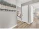 Neutral hallway with modern artwork, door, and wood-look flooring, creating a serene and stylish passage at 5102 Tennis Ct, Las Vegas, NV 89120