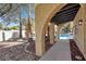 Covered patio with arched openings leading to a sparkling pool at 5102 Tennis Ct, Las Vegas, NV 89120