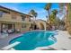 Inviting pool with diving board, patio furniture, and a two-story home with desert landscaping at 5102 Tennis Ct, Las Vegas, NV 89120