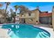 Inviting pool with diving board, patio furniture, and a two-story home with desert landscaping at 5102 Tennis Ct, Las Vegas, NV 89120