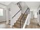 Modern staircase with wood treads and decorative iron railing, adding a touch of elegance to the home at 5102 Tennis Ct, Las Vegas, NV 89120