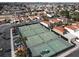 Aerial view of community tennis courts, palm trees, and residential neighborhood, creating a recreational community at 5102 Tennis Ct, Las Vegas, NV 89120