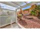 A backyard featuring desert landscaping, shade, and an enclosed privacy fence at 5185 Briar Meadow Way, Las Vegas, NV 89118