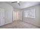 Large carpeted bedroom with a ceiling fan, window, and doorways leading to other rooms at 5185 Briar Meadow Way, Las Vegas, NV 89118