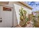 Close-up of the front entrance with a white door and a decorative window, complemented by desert landscaping at 5185 Briar Meadow Way, Las Vegas, NV 89118