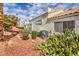 Exterior view shows well-maintained landscaping and the architectural style of the homes in the community at 5185 Briar Meadow Way, Las Vegas, NV 89118