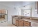 Bright kitchen with stainless steel appliances, light wood cabinets, breakfast bar, and tile flooring at 5185 Briar Meadow Way, Las Vegas, NV 89118