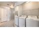 Laundry area with washer, dryer, and shelving for convenient storage at 5185 Briar Meadow Way, Las Vegas, NV 89118