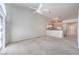 Bright open-concept living room with a ceiling fan, lots of natural light, and views of the kitchen at 5185 Briar Meadow Way, Las Vegas, NV 89118