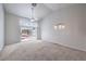 Bright living room with vaulted ceiling, ceiling fan, and sliding glass doors leading to the backyard at 5185 Briar Meadow Way, Las Vegas, NV 89118