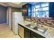 Well-lit kitchen featuring tile floors, stainless steel appliances, and a practical layout, perfect for cooking at 5330 Rod Ct # 202, Las Vegas, NV 89122