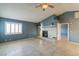 Bright living room with tile flooring, a fireplace with decor, and a large window with shutter-style blinds at 5330 Rod Ct # 202, Las Vegas, NV 89122