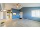 Spacious living room featuring tile floors, ceiling fans, and an open layout connecting to the adjacent kitchen at 5330 Rod Ct # 202, Las Vegas, NV 89122