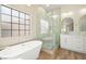 Luxurious bathroom featuring a soaking tub, a glass-enclosed shower, and elegant fixtures at 5520 Cranwood Ct, Las Vegas, NV 89130