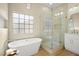 Elegant bathroom featuring a soaking tub, walk-in shower, and modern fixtures at 5520 Cranwood Ct, Las Vegas, NV 89130