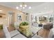 Dining area with glass-top table with easy access to living room, kitchen, and bright front sitting room at 5520 Cranwood Ct, Las Vegas, NV 89130