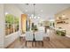 Bright dining room features natural light, modern chandelier and flows to kitchen and living spaces at 5520 Cranwood Ct, Las Vegas, NV 89130