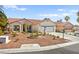 Well-kept house featuring a landscaped yard and a two-car garage with an extended driveway at 5520 Cranwood Ct, Las Vegas, NV 89130