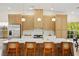 Modern kitchen with stainless steel appliances, white countertops, and stylish wooden cabinetry at 5520 Cranwood Ct, Las Vegas, NV 89130