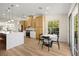 Kitchen with stainless appliances, sleek cabinets, and dining area with natural light streaming in at 5520 Cranwood Ct, Las Vegas, NV 89130