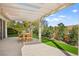 Outdoor patio with pergola, offering shade for dining and relaxation amidst lush landscaping at 5520 Cranwood Ct, Las Vegas, NV 89130