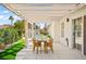 Outdoor patio seating area with a wooden table and chairs near the pool at 5520 Cranwood Ct, Las Vegas, NV 89130