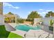 Backyard with a refreshing swimming pool, a patio area, and lush landscaping at 5520 Cranwood Ct, Las Vegas, NV 89130