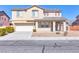 Two-story home featuring a two-car garage, covered porch, and low-maintenance landscaping at 5616 Dunshee Vista Ave, Las Vegas, NV 89131