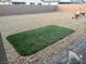 Backyard featuring a patch of green grass surrounded by gravel at 5980 E Drosetta Ave, Pahrump, NV 89061