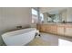 Relaxing bathroom with soaking tub, dual vanities, and stylish fixtures at 6009 Silvalde Ln, Las Vegas, NV 89135