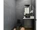 Modern powder room with black fixtures, textured walls, and a vessel sink at 6009 Silvalde Ln, Las Vegas, NV 89135