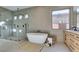 Modern bathroom features a large shower and a freestanding soaking tub at 6009 Silvalde Ln, Las Vegas, NV 89135